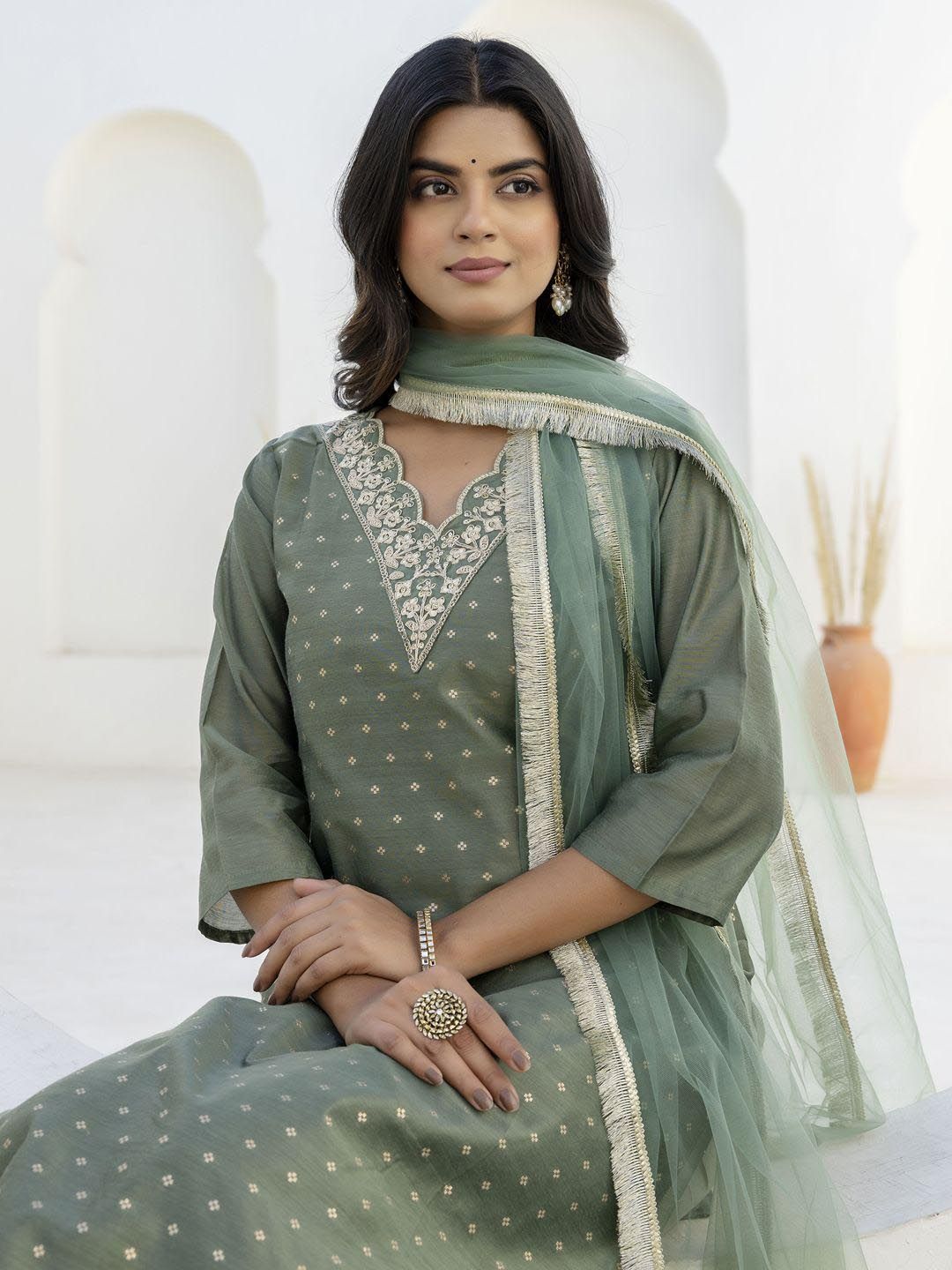 Dhimhi women's ethnic kurta pant set with dupatta featuring traditional patterns and vibrant colors on a model.
